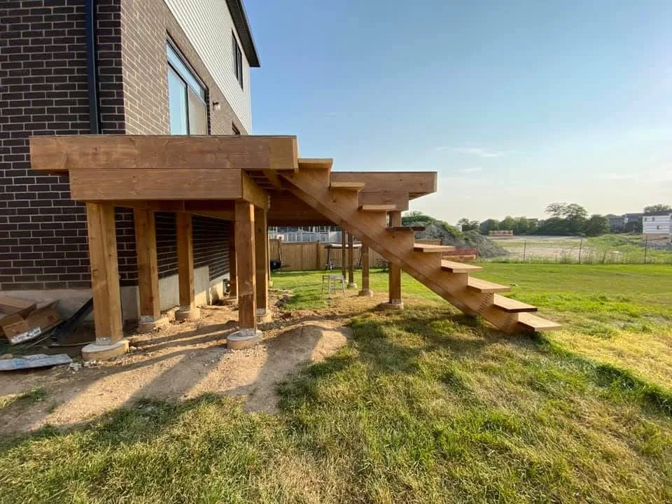 Raised wood deck and stairs during construction before railings