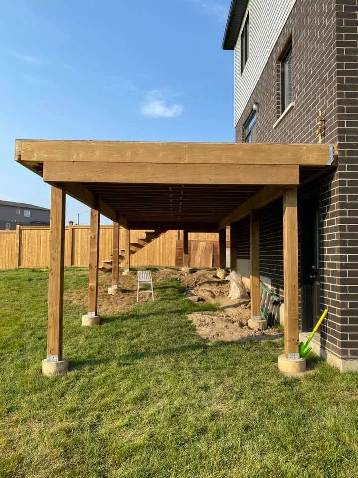 Side view of wood deck support posts and framing